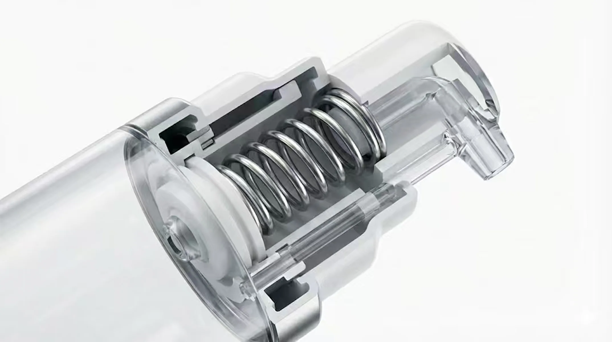 Close-up of an airless pump mechanism showing the internal spring and nozzle structure.