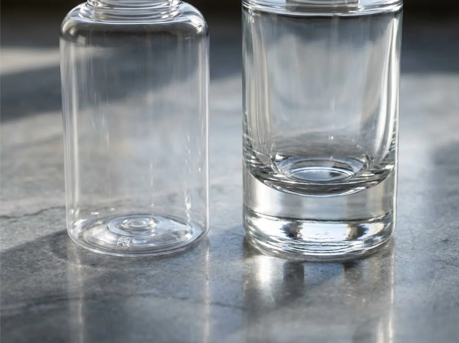 Visual comparison: The texture difference between a clear plastic bottle and a heavy-bottom glass bottle.