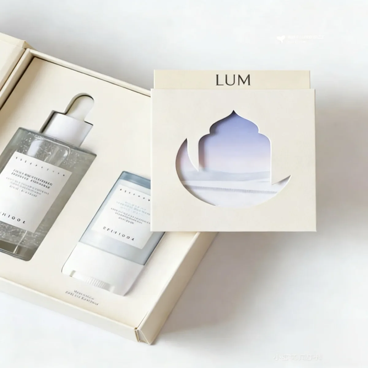 Rigid box with custom die-cut insert designed to securely hold glass dropper bottles and cosmetic tubes.