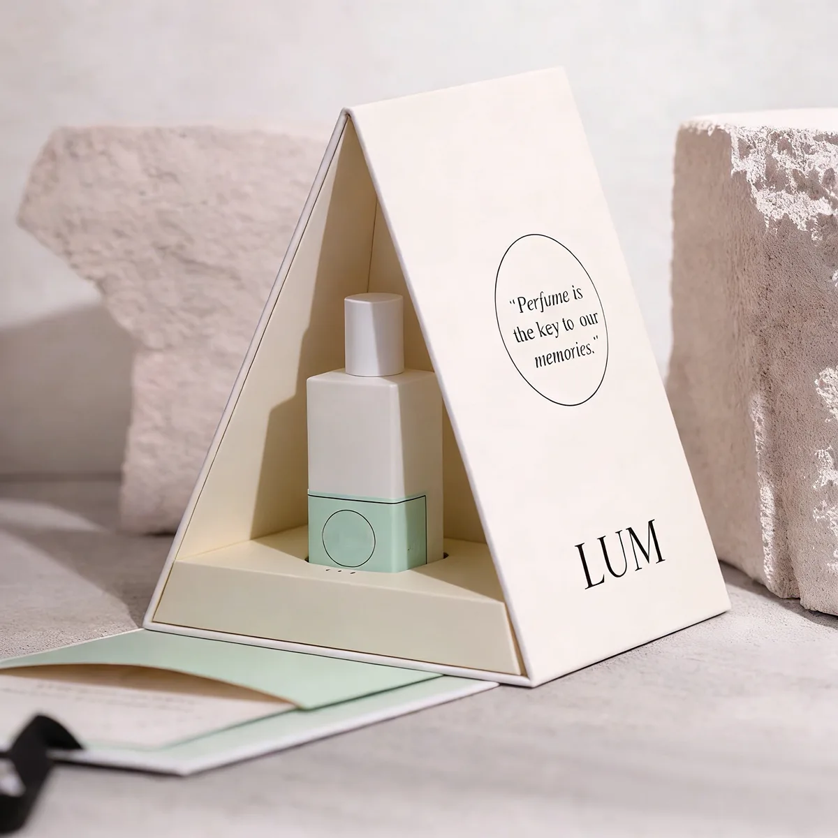 Triangular geometric packaging manufactured by Lumlun, featuring the LUM logo on a premium die-cut presentation box.