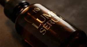 Amber glass dropper bottle with gold hot stamping logo design for premium skincare