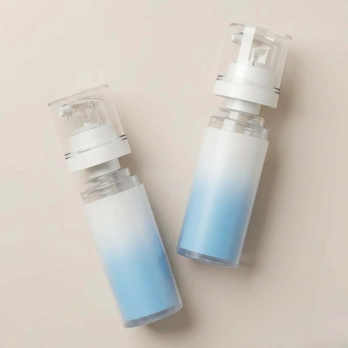 Blue and white seamless gradient spray coating on airless bottles
