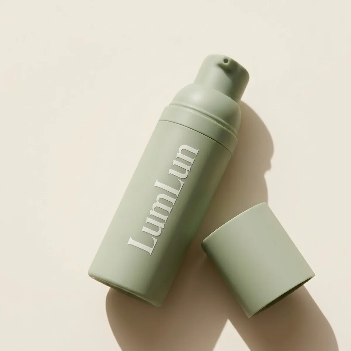 White silk screen logo printing on a sage green airless bottle