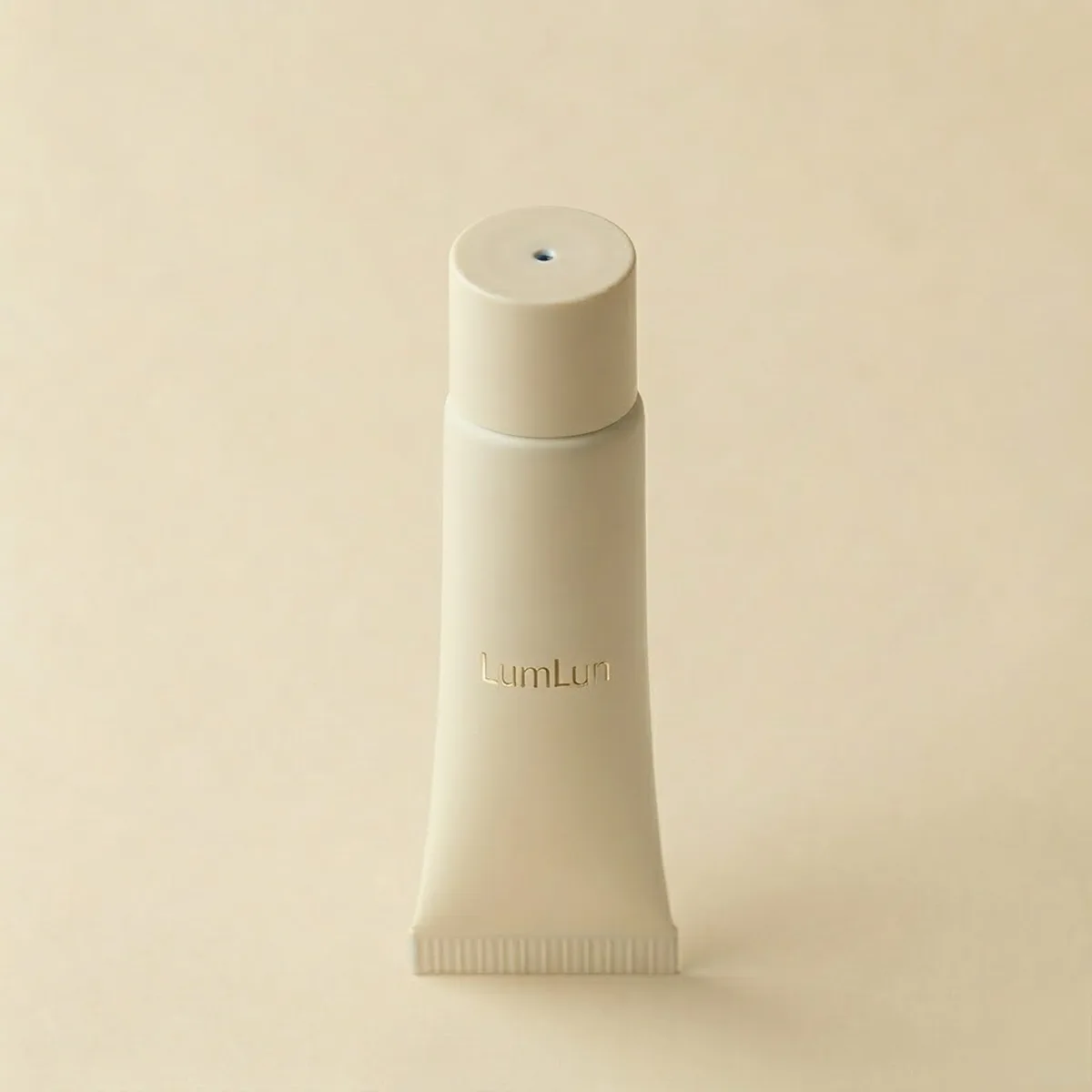 Beige tube with a twist-lock dispensing cap, available at our cosmetic tube factory.