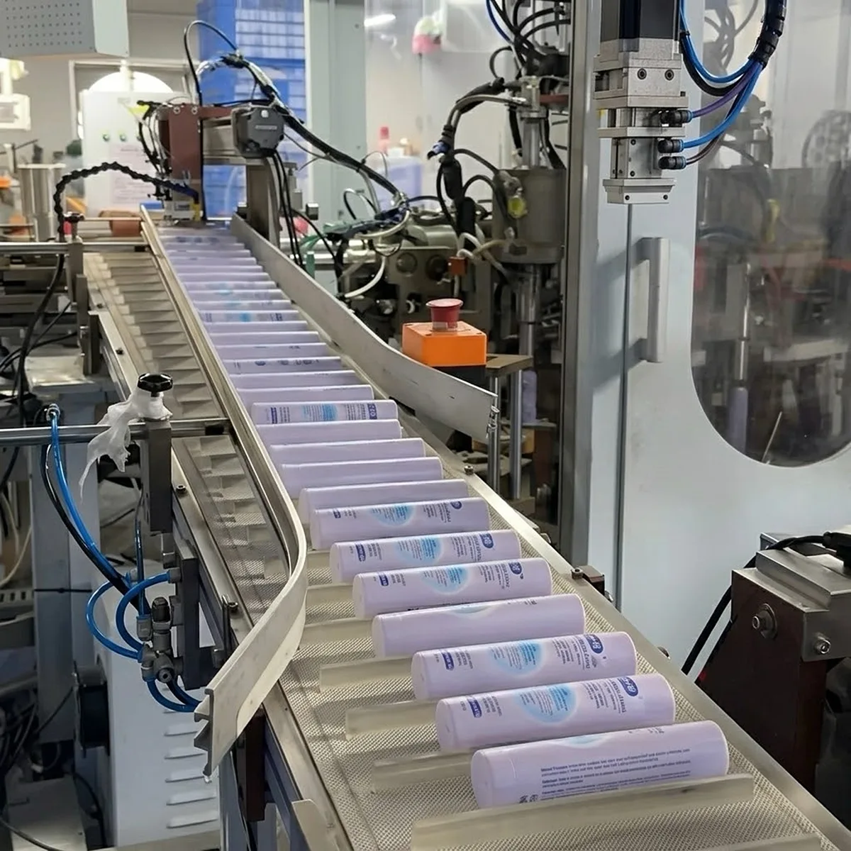 High-speed automated production line for mass manufacturing of cosmetic plastic tubes.