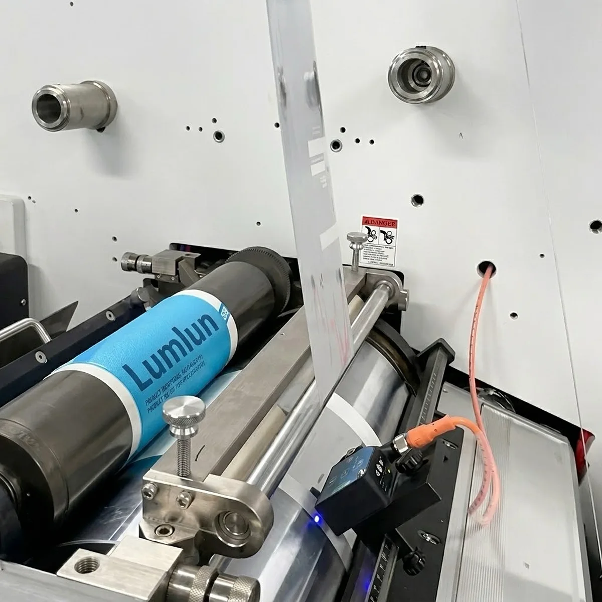 Precision offset printing process applying custom brand logos on cosmetic tubes.