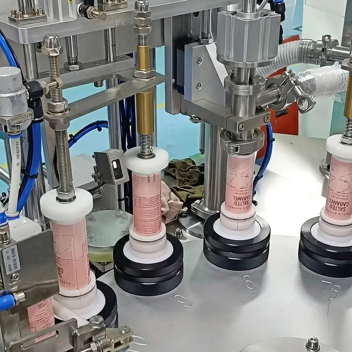 High-speed rotary capping station for cosmetic tubes with automated torque testing.