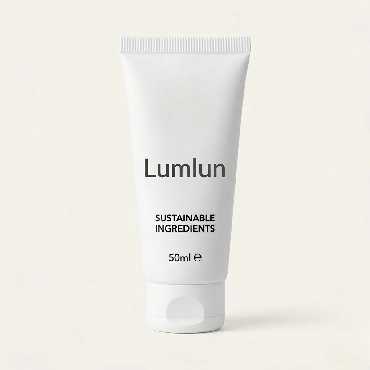 White cosmetic tube with a tactile black silk-screened logo showing thick ink texture.