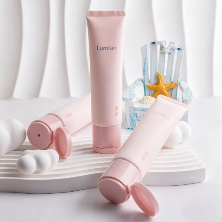 Custom 35mm pink matte hand cream tubes with minimalist branding on a textured background.