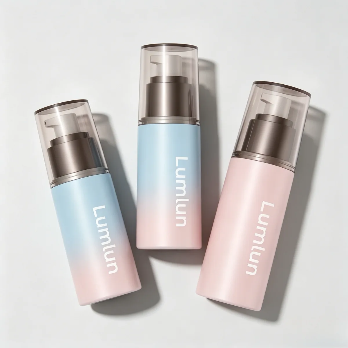 Three custom blue and pink gradient AS airless bottles with white Lumlun branding logo