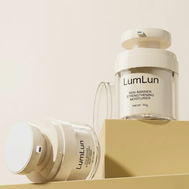 Two cream white PP inner cup clear AS airless cream jars — one upright on a golden platform showing full label and pump mechanism, one laid on its side showing the clear outer shell and LumLun branding, OEM custom moisturizer packaging