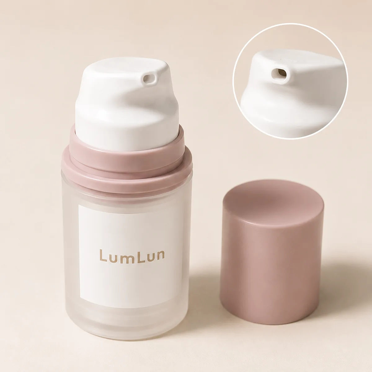 Close-up detail of 30ml frosted PP airless bottle with dusty pink collar showing white dome pump head with side nozzle dispensing hole, detached cylindrical pink cap beside it, with circular magnified inset showing nozzle opening detail, LumLun OEM airless packaging