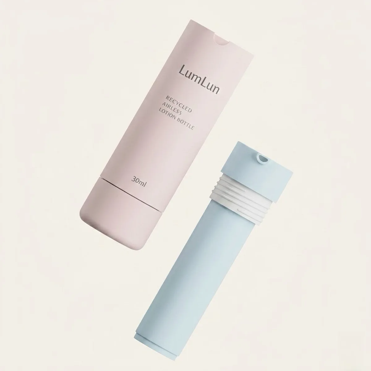 Pink gradient 30ml refillable airless pump bottle labeled "Recycled Airless Lotion Bottle" beside a blue ABS outer shell with exposed white PP inner refill cartridge showing replaceable mechanism — LumLun OEM sustainable serum packaging