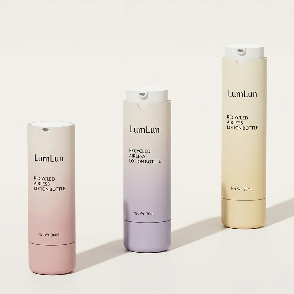 Three gradient refillable airless pump bottles in rose pink, muted purple, and cream beige — all 30ml with "Recycled Airless Lotion Bottle" label and LumLun branding — ABS shell with replaceable PP inner, OEM custom serum and lotion packaging