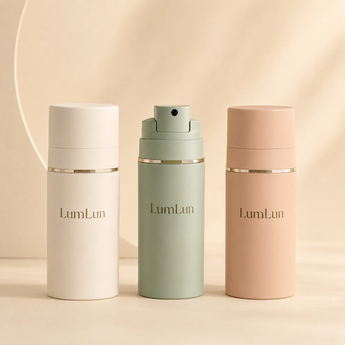 Three matte PP airless pump bottles in white, sage green, and blush pink with center bottle showing open pump head and gold accent ring, LumLun OEM custom airless skincare bottle series
