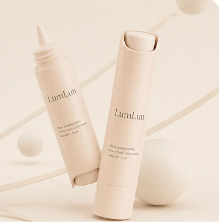 Two beige PP airless press stick bottles — one lying flat showing nozzle tip, one standing upright — slim cylindrical format for serum and essence OEM branding, LumLun custom packaging