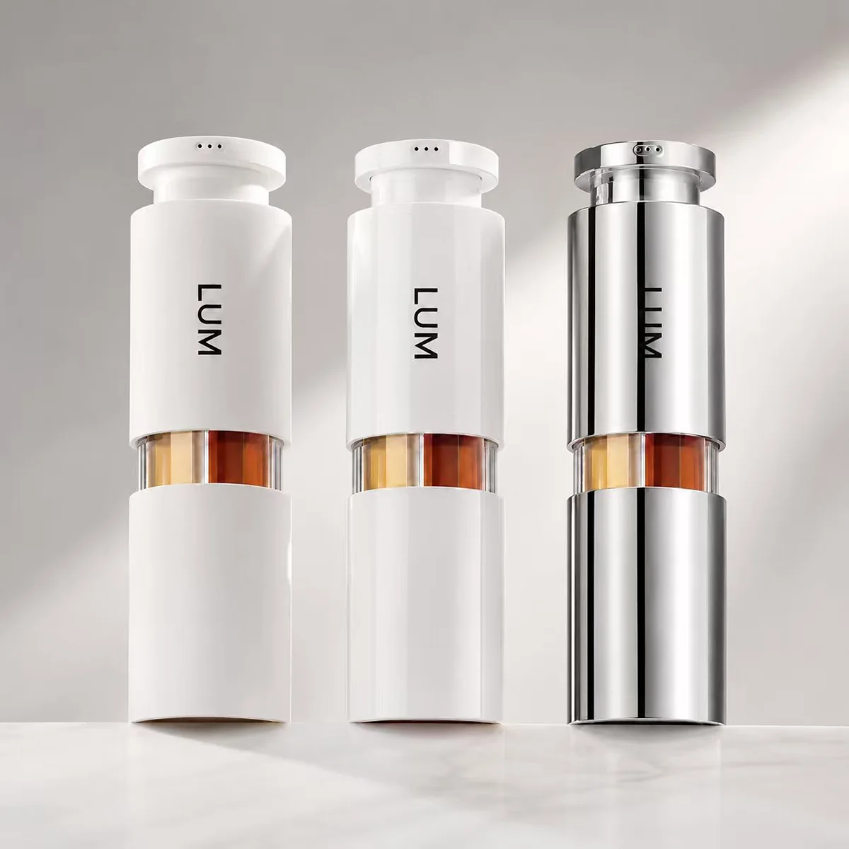 Surface finish options for multi-chamber airless bottles: matte white, glossy white, and vacuum metallized chrome