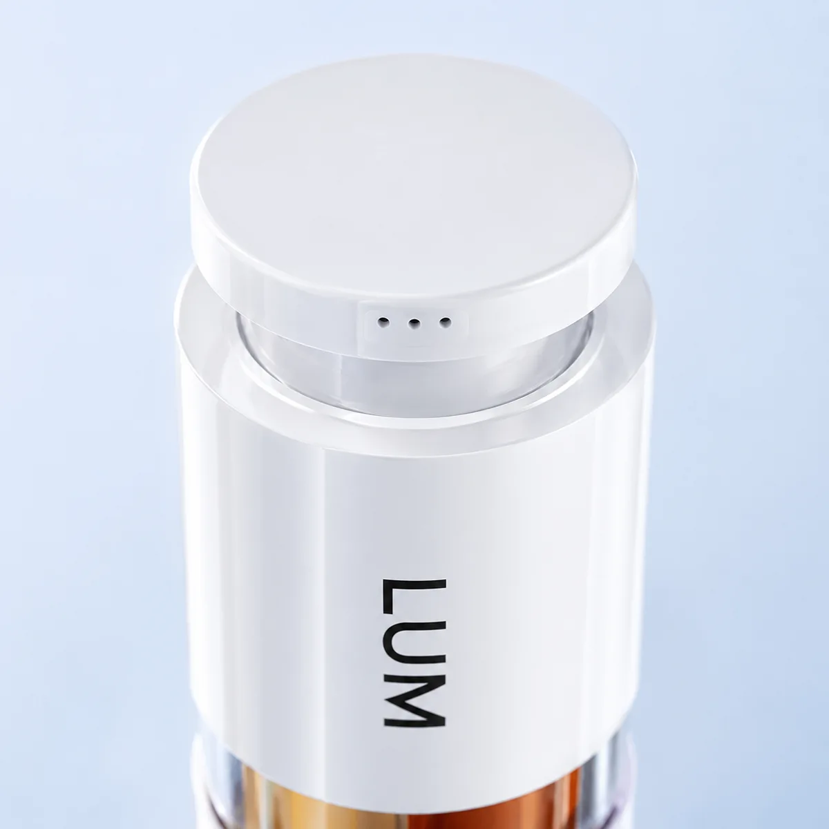 Close-up of the twist-to-open dispensing mechanism on the 3-in-1 multi-chamber airless bottle