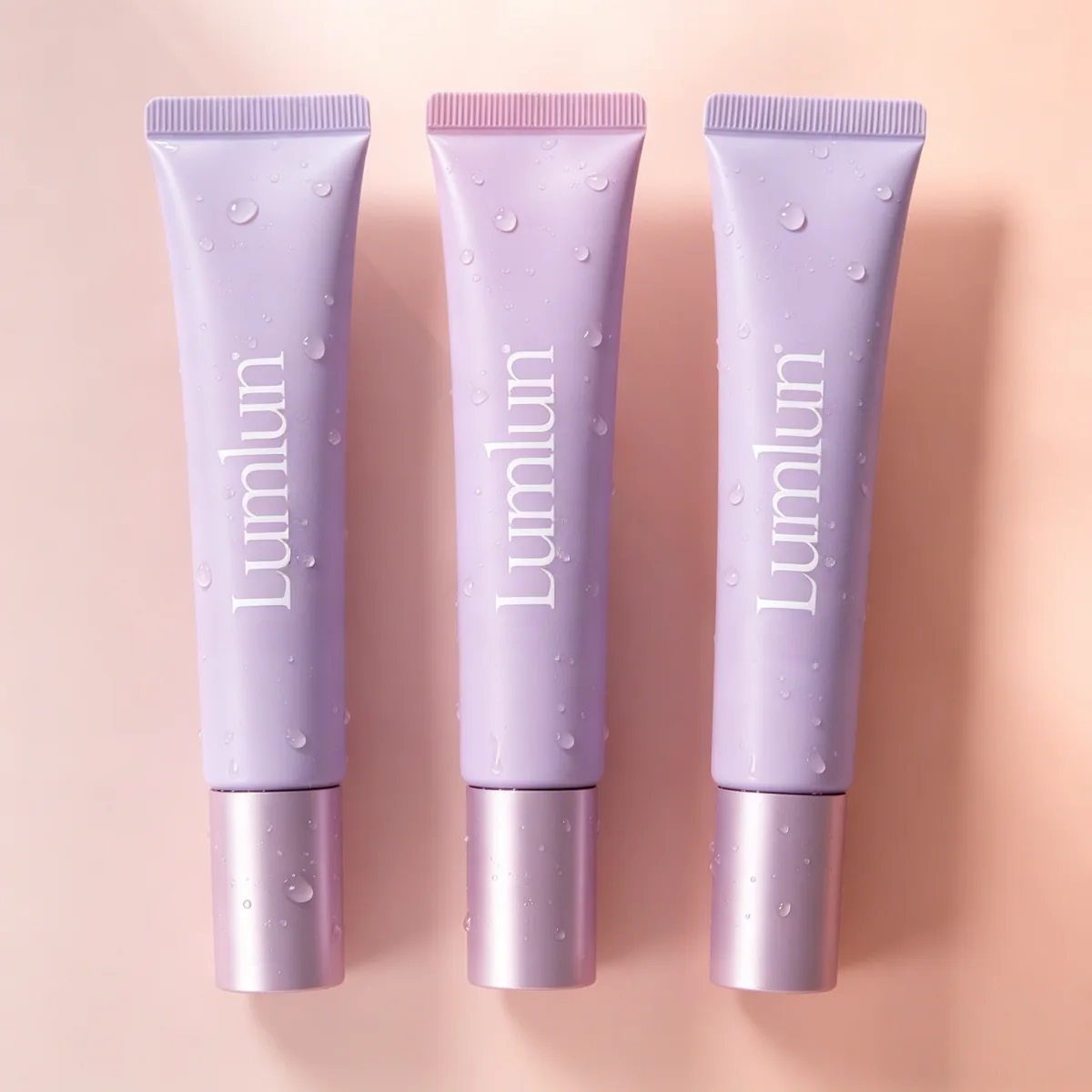 Matte purple and pink 15ml lip care tubes showing the precision silicone dispensing head.