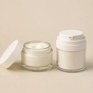 Traditional open screw-lid cream jar next to a modern airless pump jar for skincare comparison