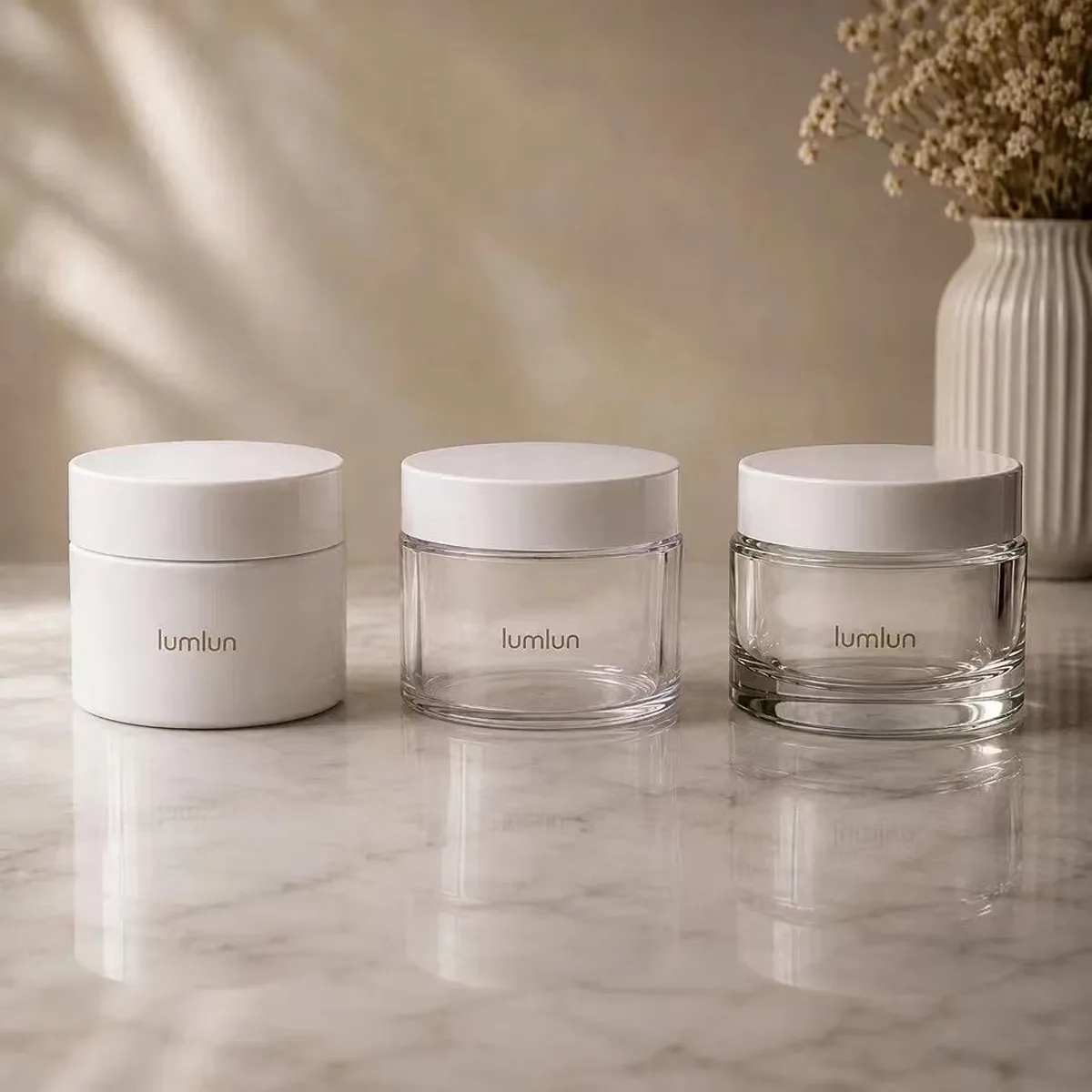 Three LumLun cream jars showing PP opaque, PETG clear tall-wall, and PETG wide-base options on white marble surface