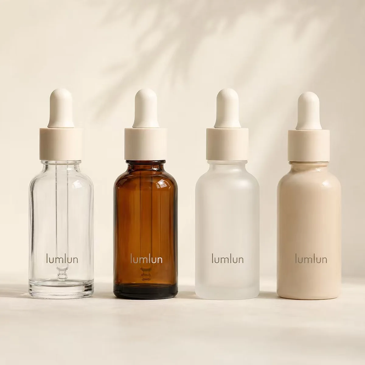 Custom serum bottles in clear, amber, frosted and beige glass showing color options for skincare brands