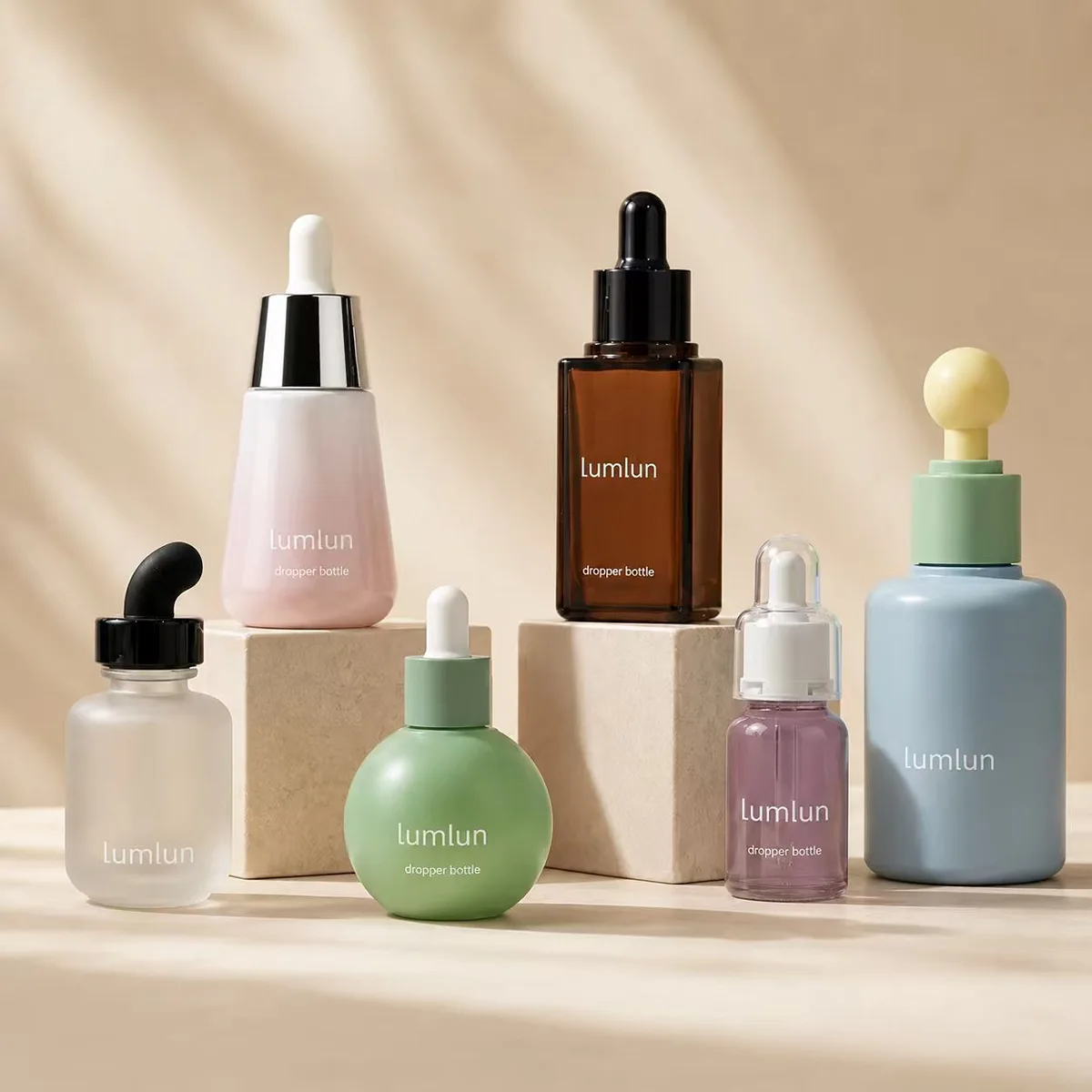 Custom serum bottles in spherical, square, curved-teat and tapered shapes showing distinctive design options