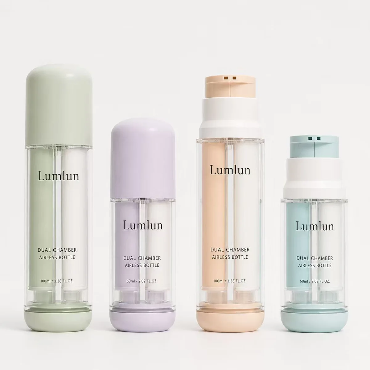 Four Lumlun dual chamber airless bottles in green, purple, beige and blue showing two independent inner chambers in 100ml and 60ml sizes for skincare brands