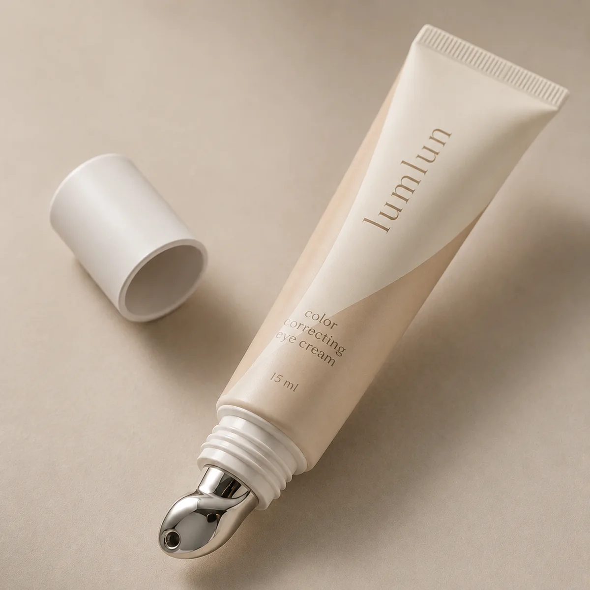 LumLun 15ml eye cream tube with a silver metal rollerball applicator and cap shown beside it