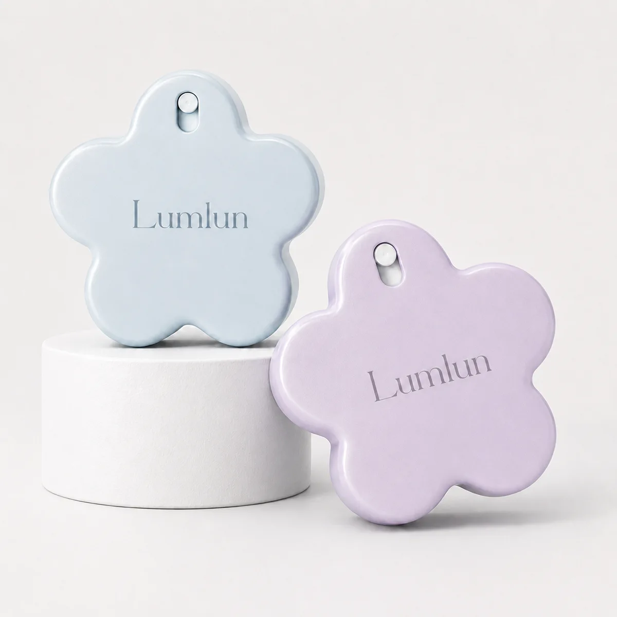 Two flower-shaped fine mist spray bottles side by side — one in powder blue and one in lilac purple, both with custom ABS outer shell and fine mist pump, showing Pantone color matching options for OEM skincare brands