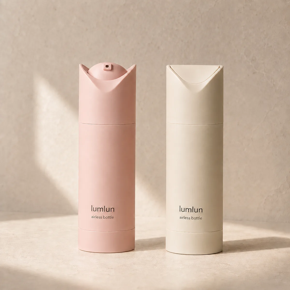 Lumlun airless bottle duo in soft pink and cream with visible twist-lock pump tops.