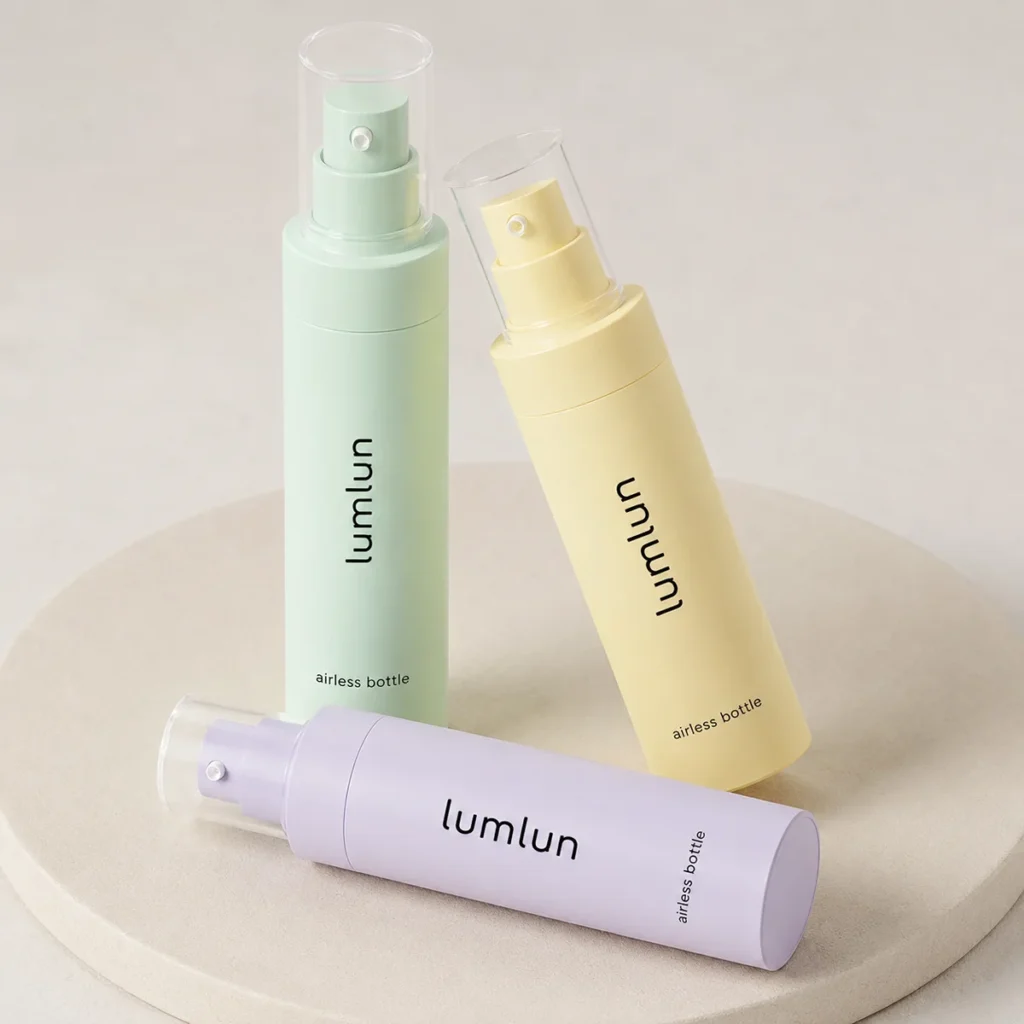 LumLun airless bottles with mist spray pumps in sage green, yellow and lilac on a round podium