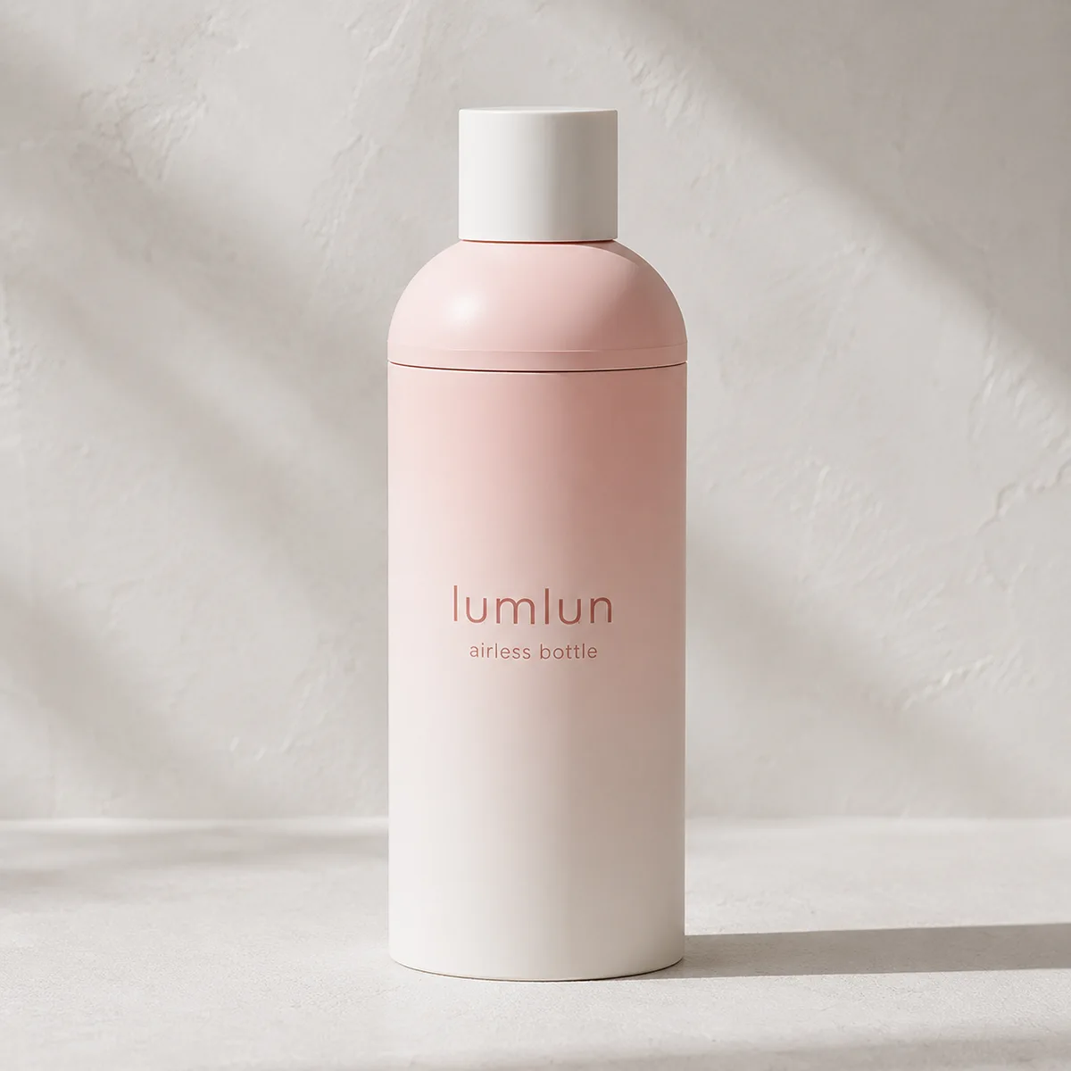 Lumlun PP airless lotion bottle in a soft pink gradient finish with a white over-cap.