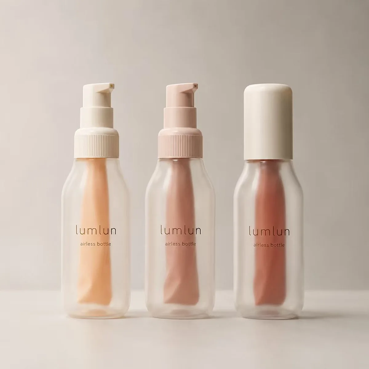 LumLun frosted airless bottles with inner pouches holding apricot, pink and rose product, two with pumps