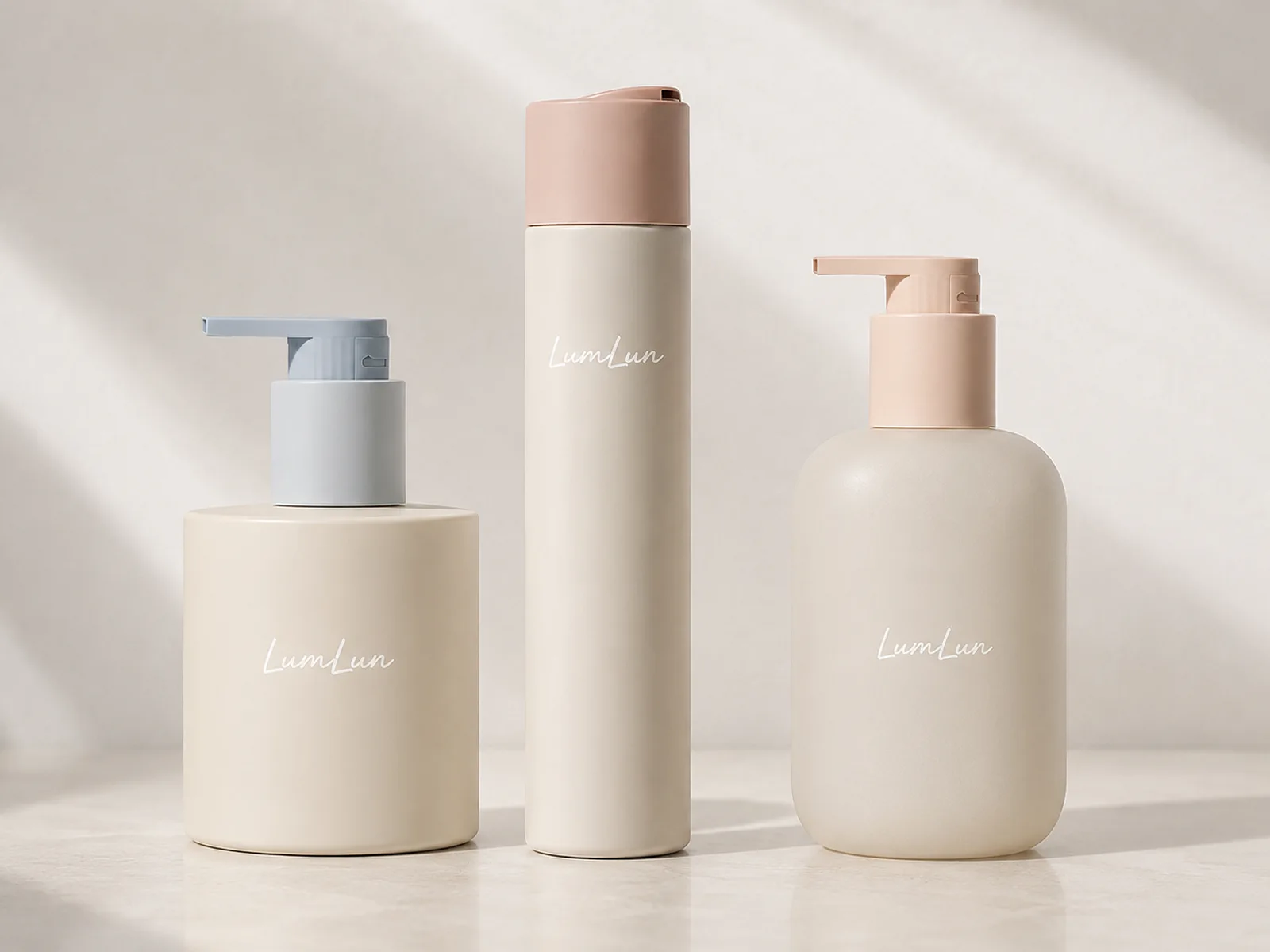 Three LumLun body lotion bottles with wide cylindrical, tall slim and rounded pump bottle proportions in soft neutral finishes