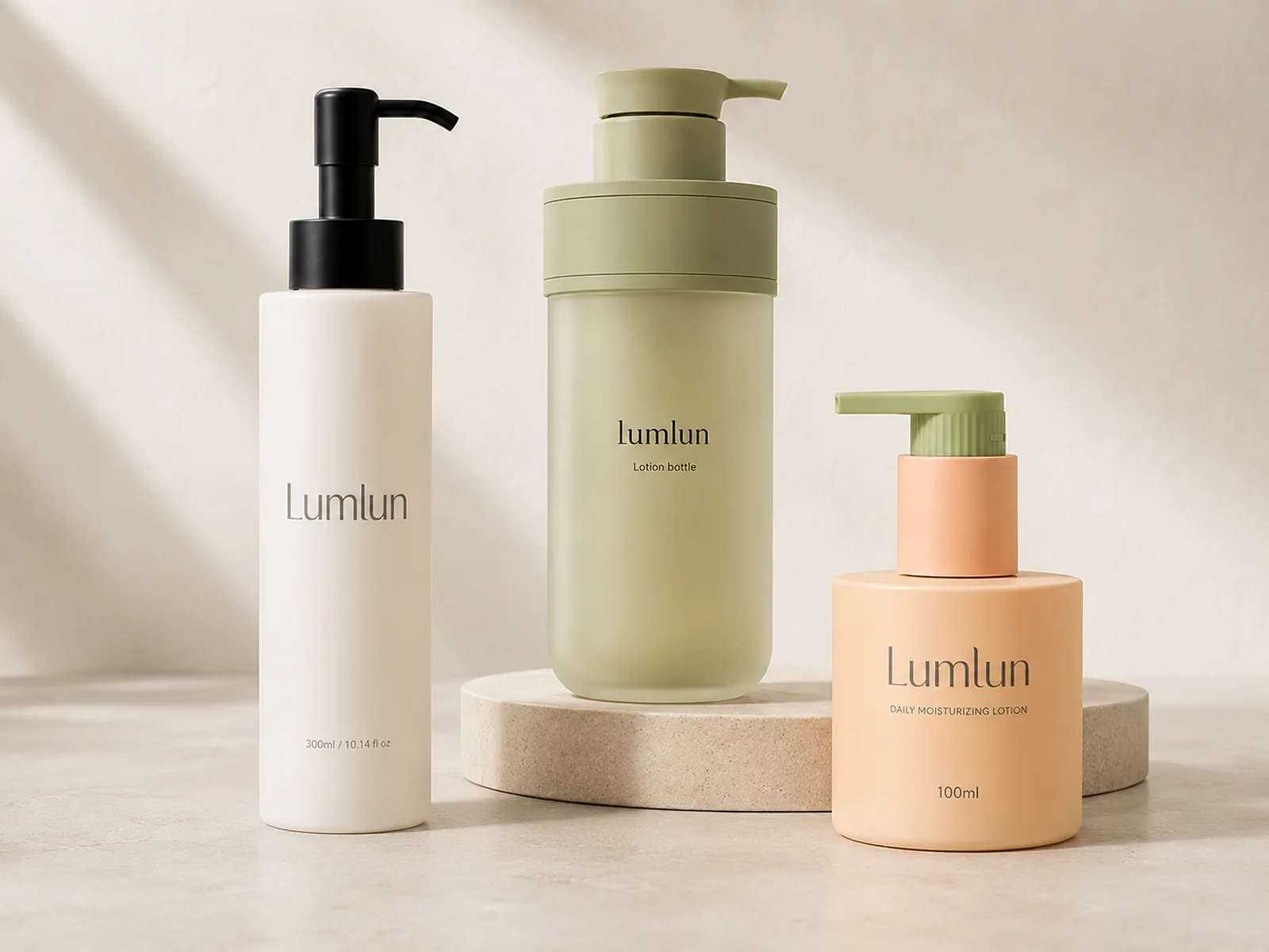 Three LumLun body lotion pump bottles in tall ivory, sage green and 100ml peach packaging designs