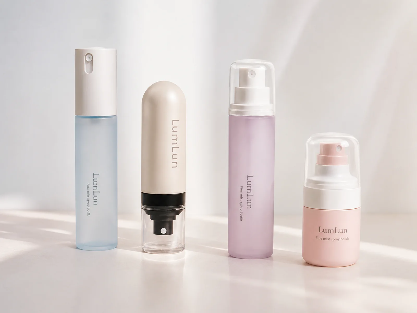 Four LumLun skincare mist bottles in blue, cream, lavender and pink with continuous and fine mist spray designs