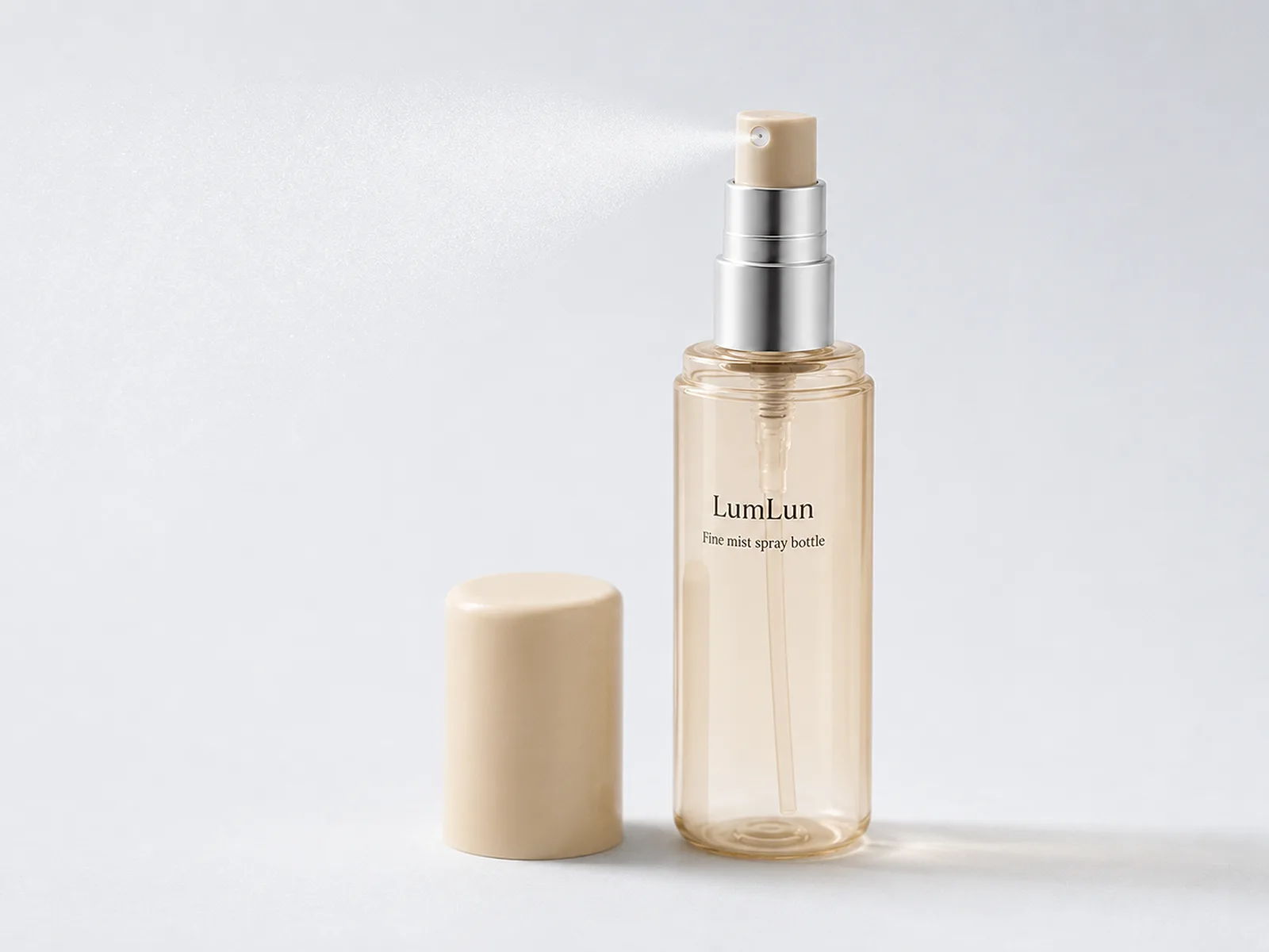 One clear amber LumLun fine mist spray bottle releasing a soft spray with its cream cap displayed beside it