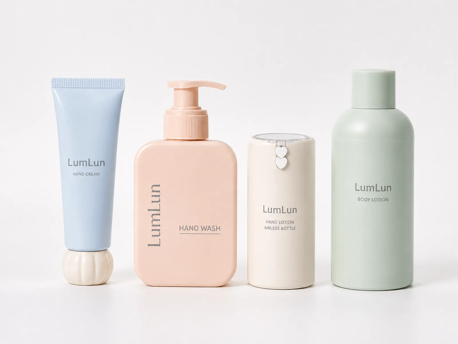 LumLun hand and body care range with a blue hand cream tube, peach hand wash bottle, ivory hand lotion bottle and sage body lotion bottle