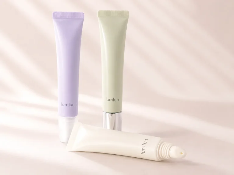 Three slim LumLun lip gloss squeeze tubes in clear, blush and pearl finishes with coordinated caps