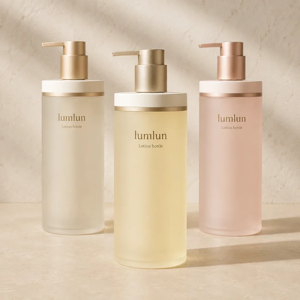 Three Lumlun pump bottles in soft white, yellow, and pink tones with metallic dispensers.