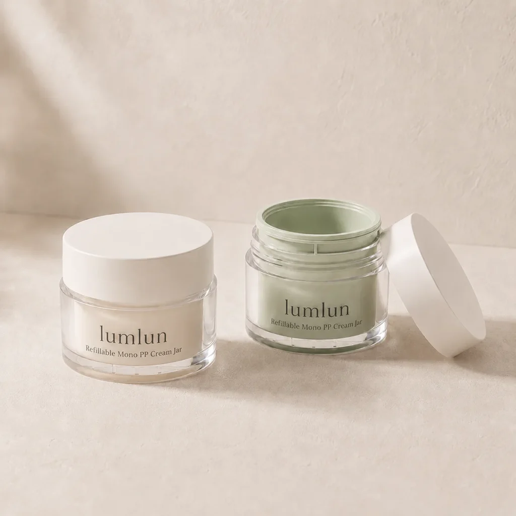 Cream and sage Lumlun refillable cream jars displayed together, one closed and one open.
