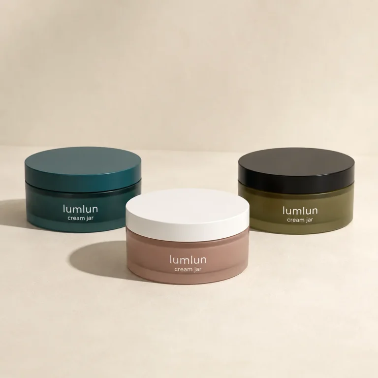 Three Lumlun cream jars in teal, olive, and taupe with contrasting flat top lids.
