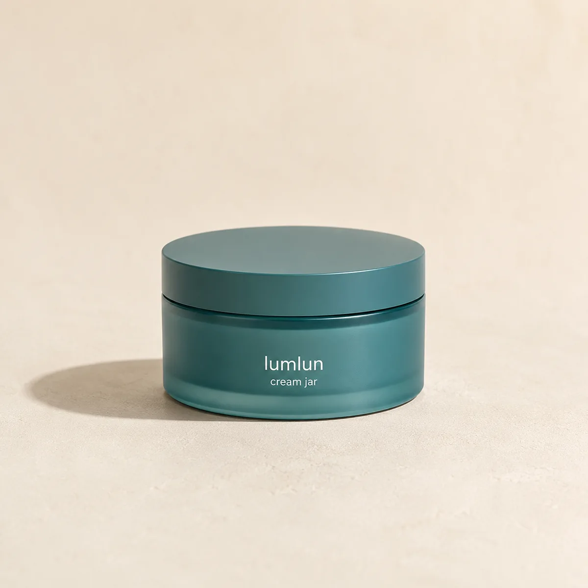 Teal Lumlun cream jar displayed on a warm beige studio background with soft natural lighting.