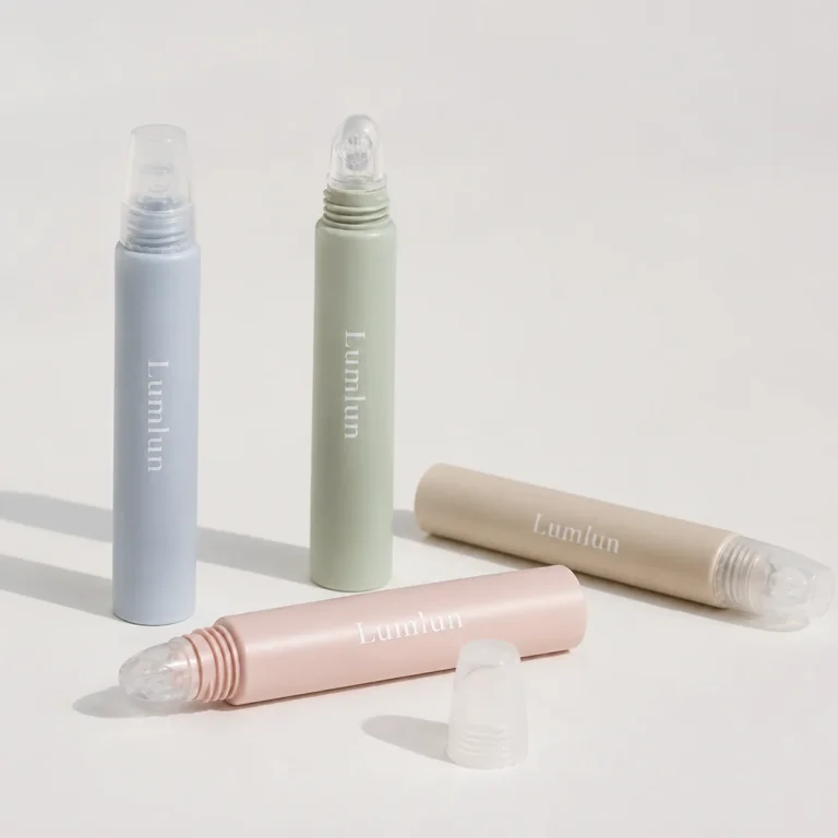 Four pastel 15ml PE lip balm squeeze tubes with clear silicone applicator tips, shown open and closed