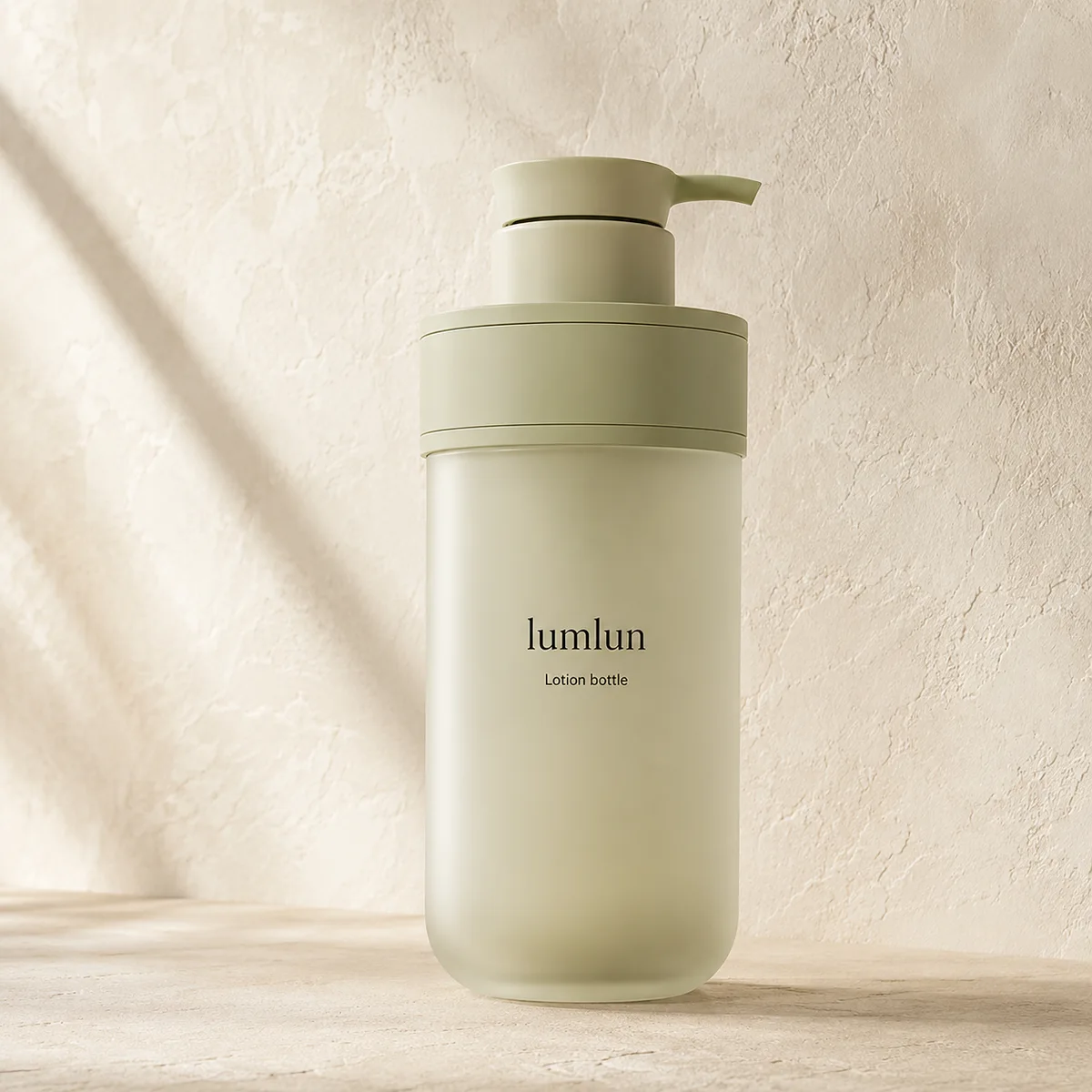 Single sage green Lumlun pump bottle with a curved dispenser on a textured beige surface.