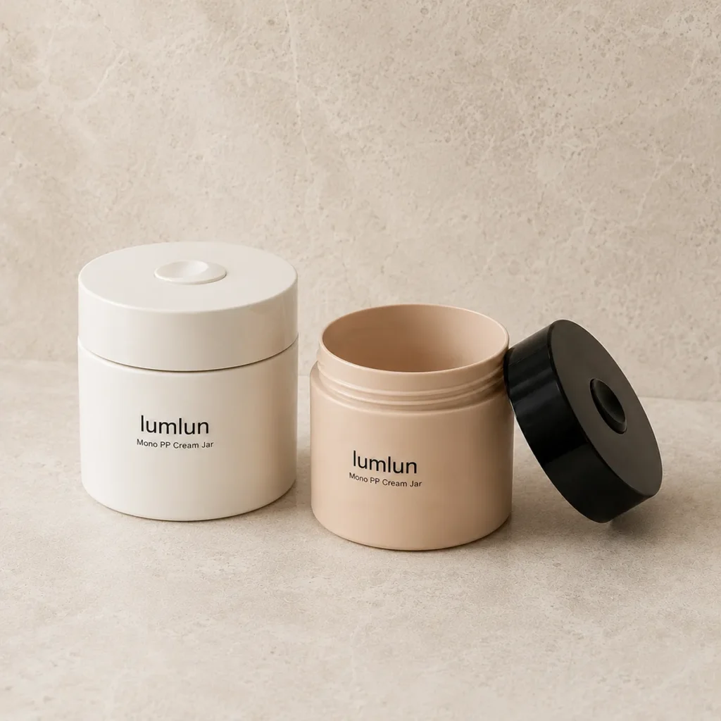 Cream and peach Lumlun Mono PP cream jars displayed with an open jar and black cap.