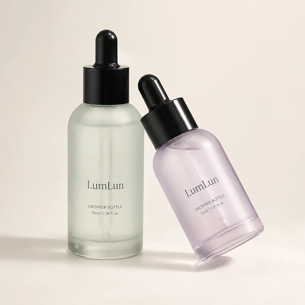 Lumlun 30ml and 70ml glass dropper bottles in green and purple with glossy black droppers.
