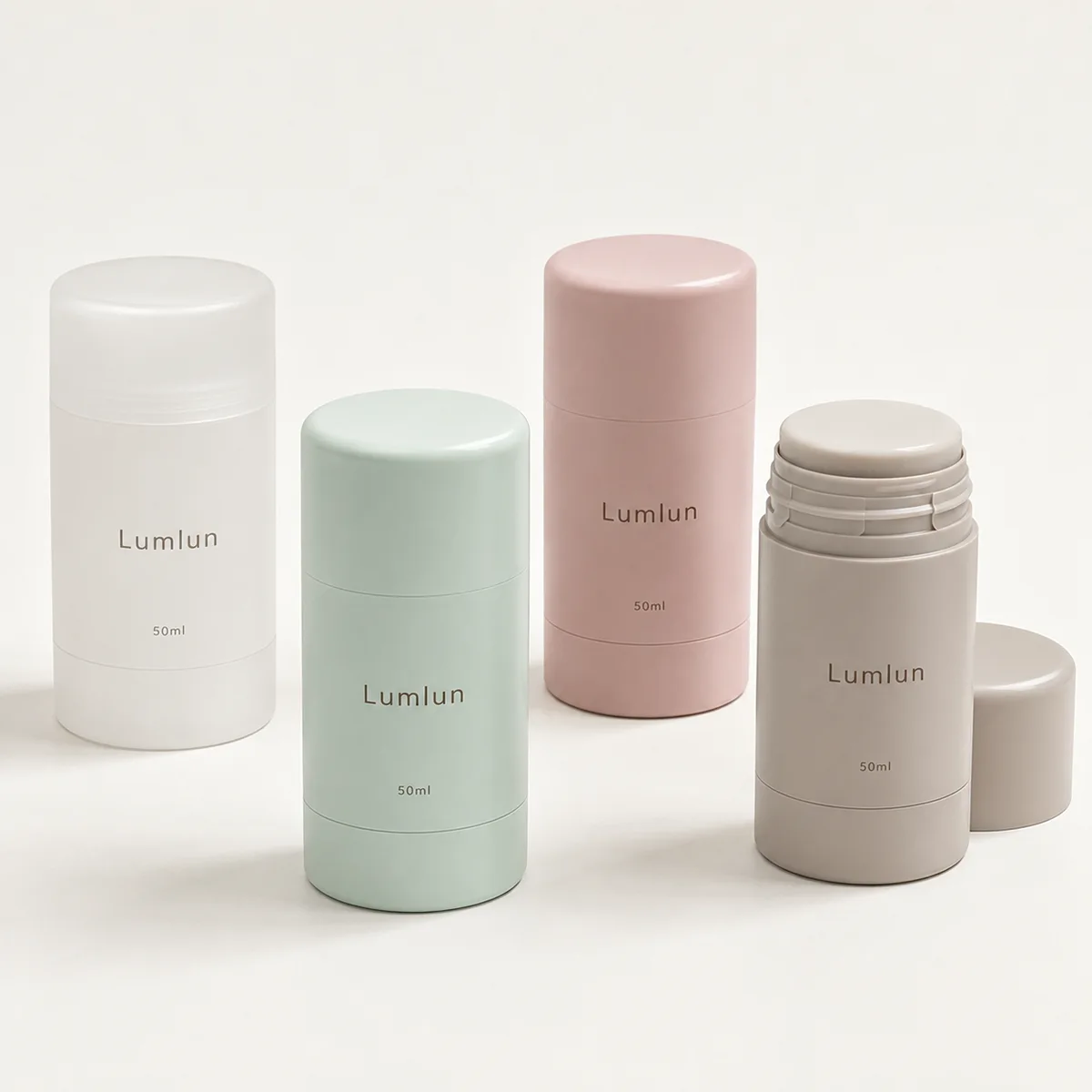 Four 50ml round PP deodorant stick containers in white, mint, pink and taupe, with one stick open