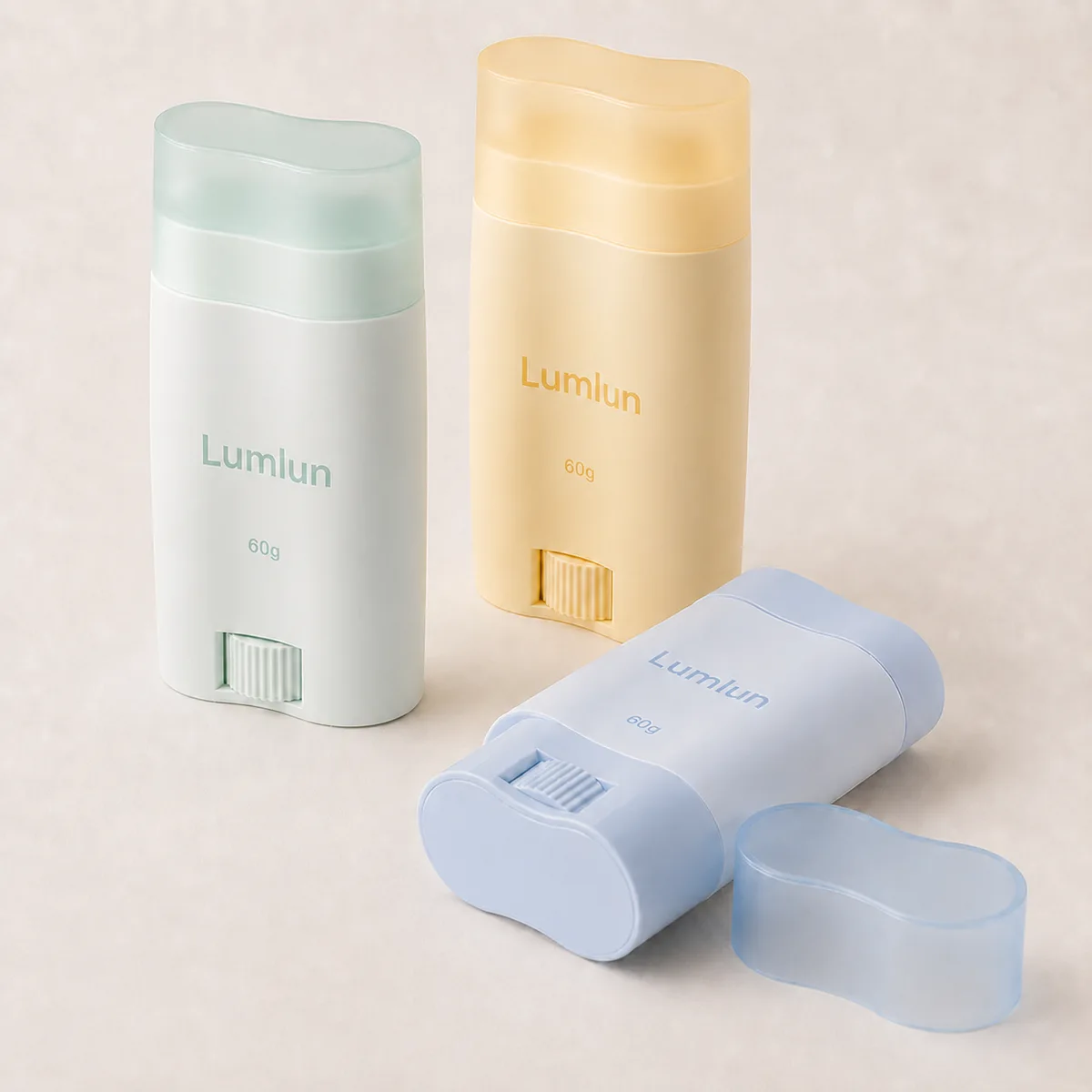 Three 60g PP contoured twist-up deodorant stick containers in white, yellow and blue with recessed bottom wheels